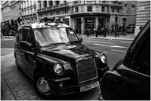 A black and white picture of an old taxi
