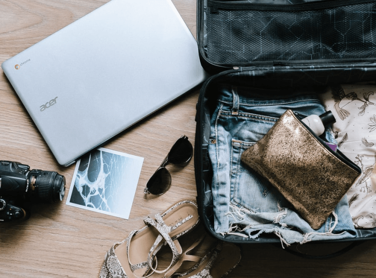 A suitcase with clothes and electronics