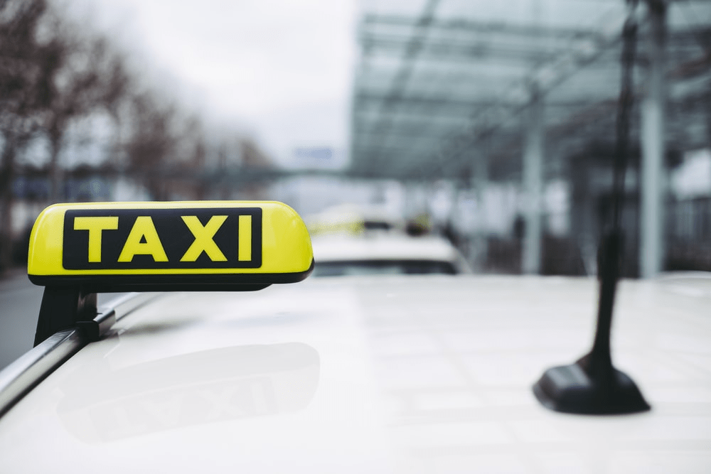 Taxi sign on top of a vehicle