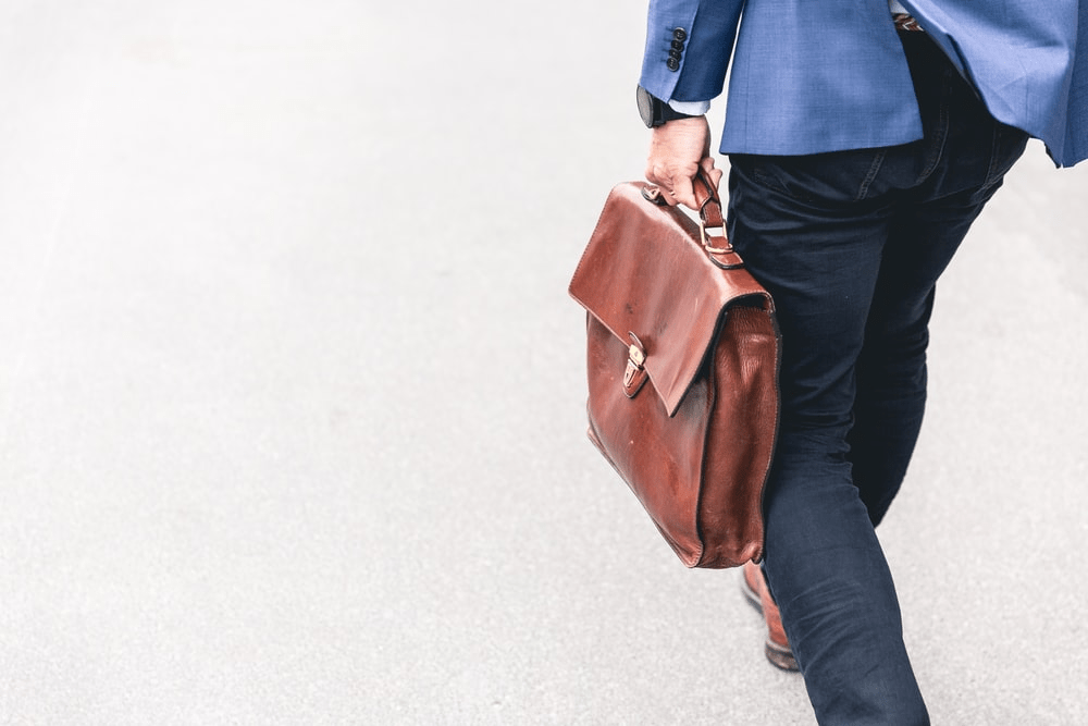 Businessman holding a leather bag 