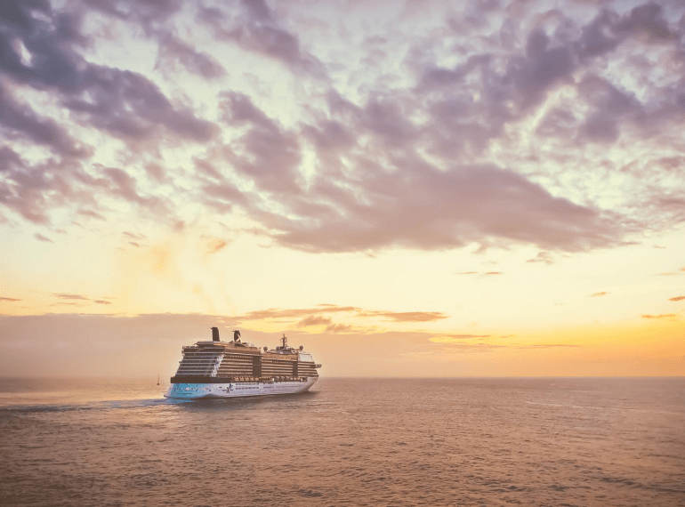 A cruise ship sailing into the sunset