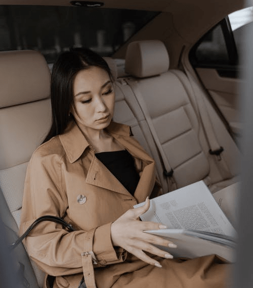 A woman is checking her documents before flight