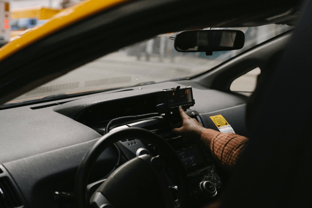 A man setting up a GPS in his taxi