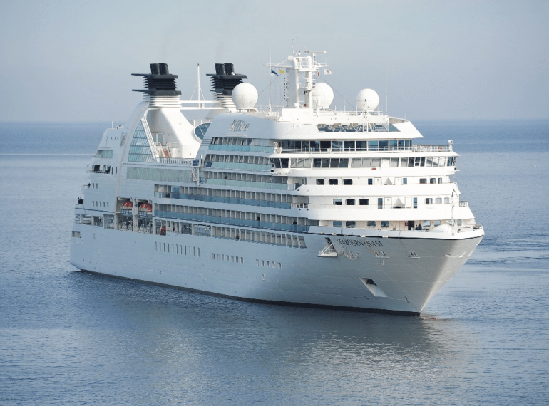 A white cruise ship leaving the cruise port
