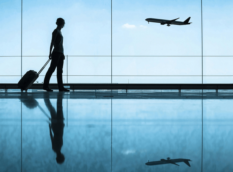 A woman is watching an aeroplane