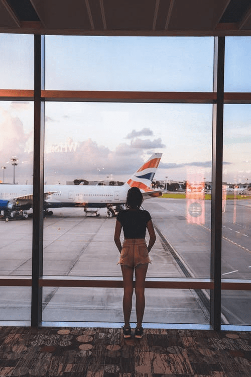  A woman looking at an aeroplane.