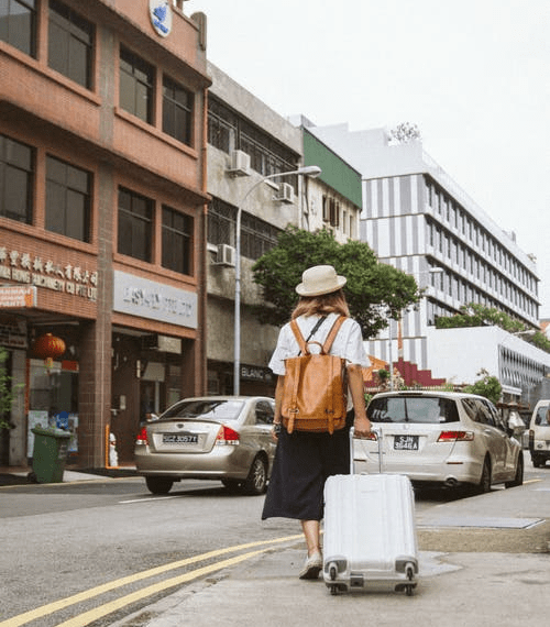 A woman travelling with her luggage.
