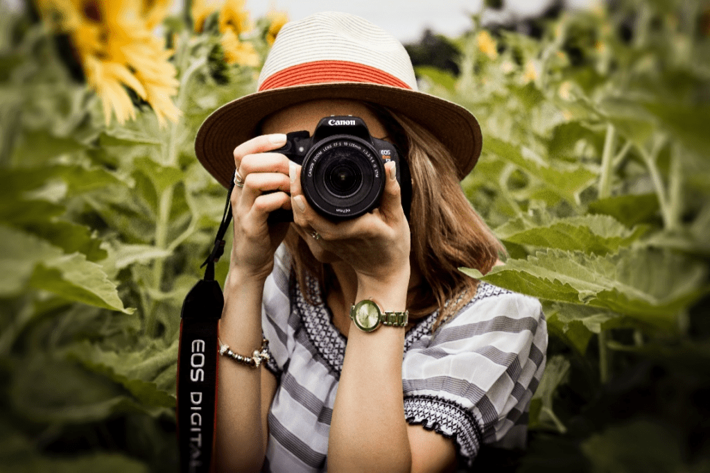 a woman holding a DSLR camera