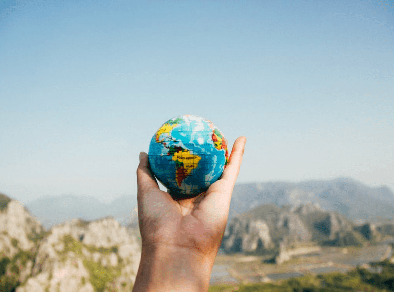 A person holding a globe