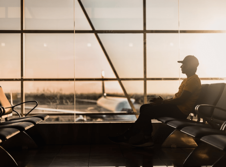 a man at the airport waiting for his flight