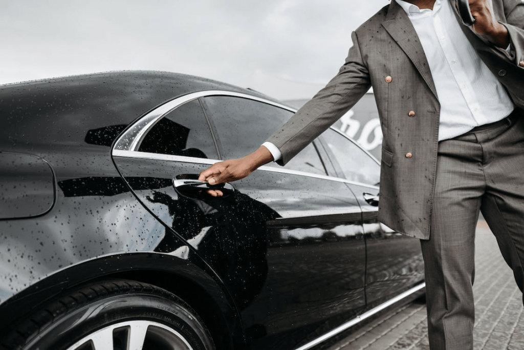 a man getting into his book airport transfer car