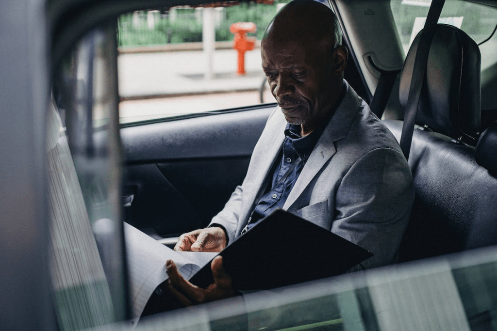 a man in an airport taxi reading information on the flight