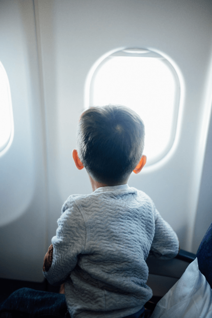 A kid sitting in an aeroplane