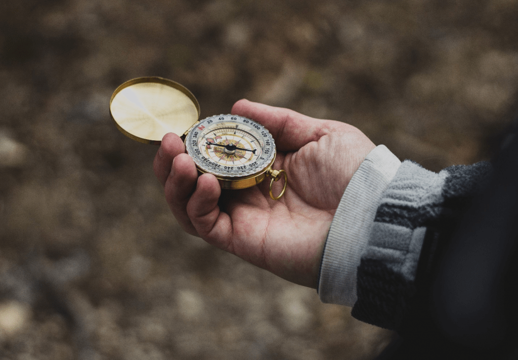 a person holding a compass in their hand