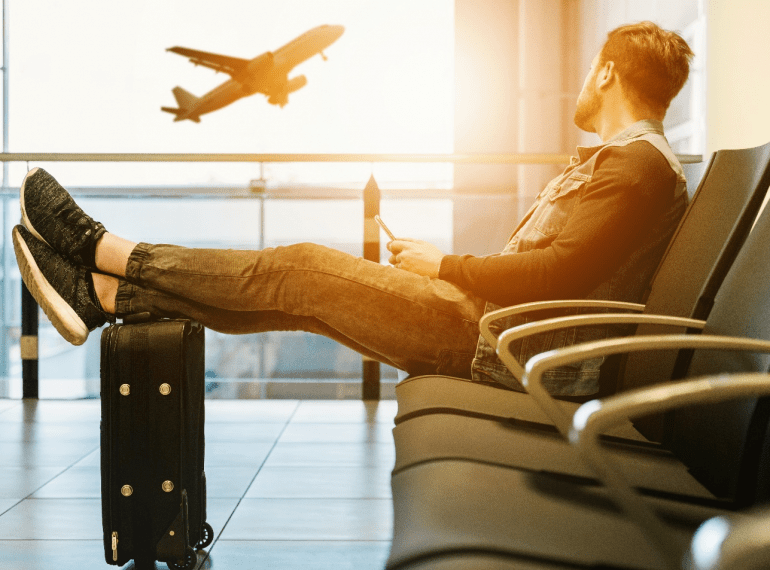 a person sitting on a black chair in a waiting lounge