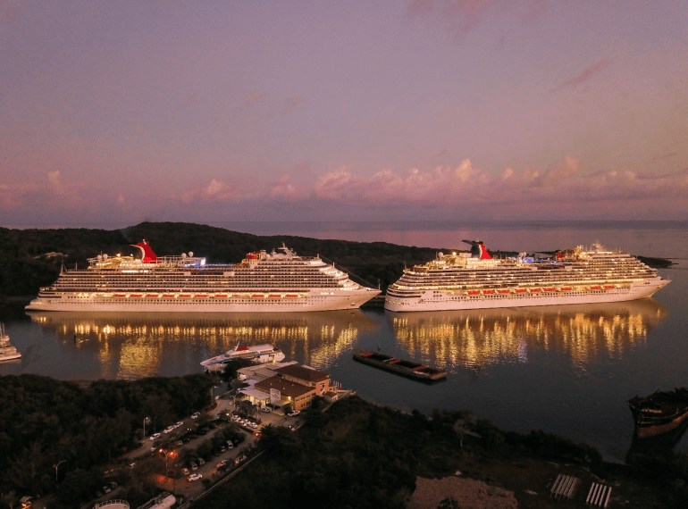 two white cruise ships sailing on the water