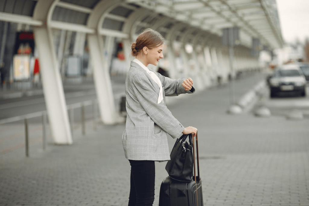 Cheerful female manager checking the time on her wristwatch