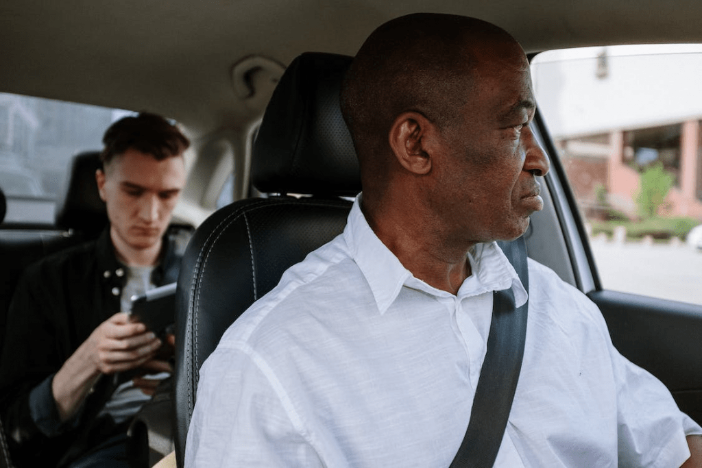 Man in a white dress shirt sitting in a car seat