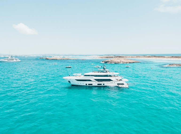 A white cruise ship in the clear ocean