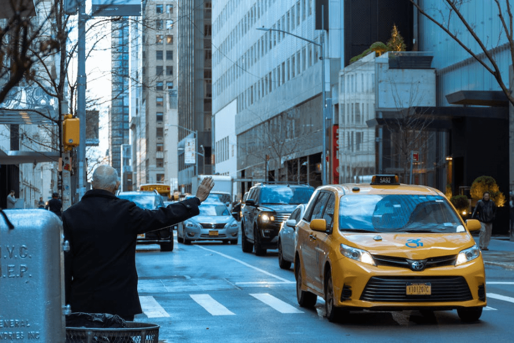 Man in Black Jacket Waiting For A Taxi Cab