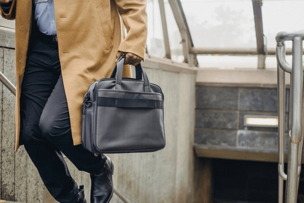 A cropped image of a faceless business man leaving an underground metro station