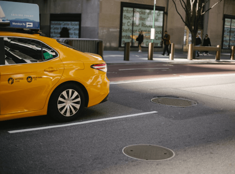 An image of a taxi parked on the side of the road