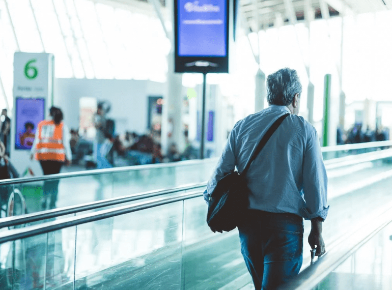 An image of a man walking through an airport terminal
