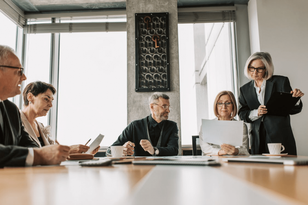 An image of a group of people in a discussion during a meeting