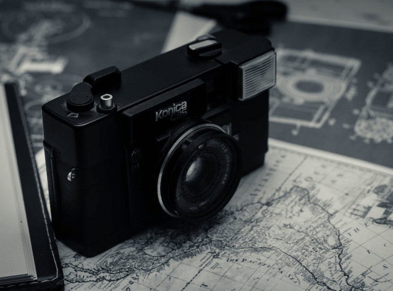 An image of a retro photo camera and a map