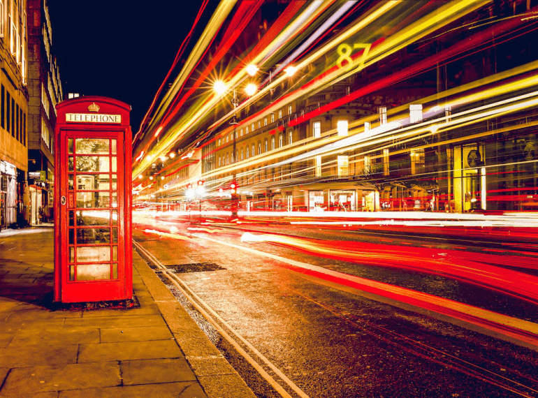 An image of a telephone booth with long exposure lights