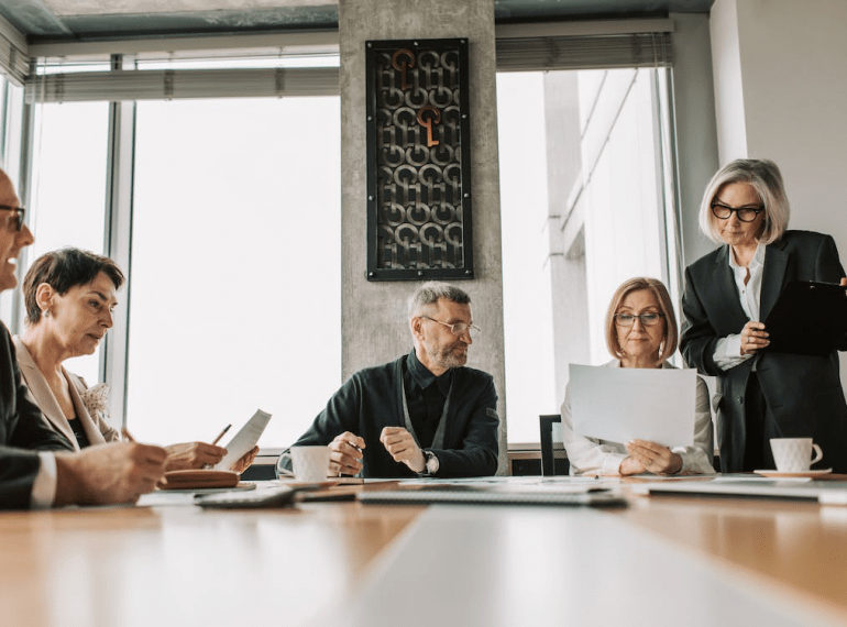 An image of a group of people in a discussion during a meeting