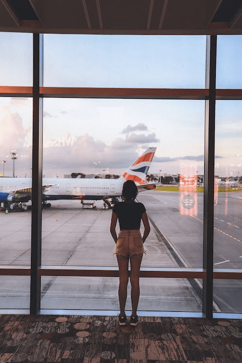 An image of a woman standing near a glass wall