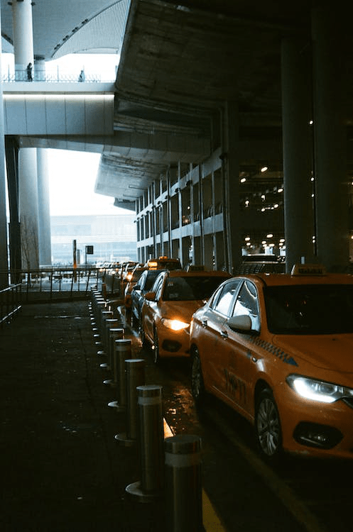 An image of several taxis parked at the airport 