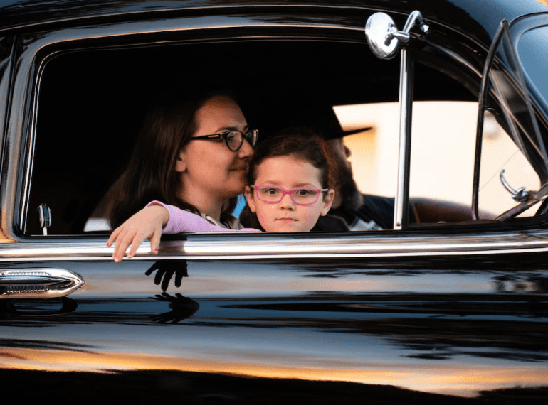 An image of a woman with a kid in a car