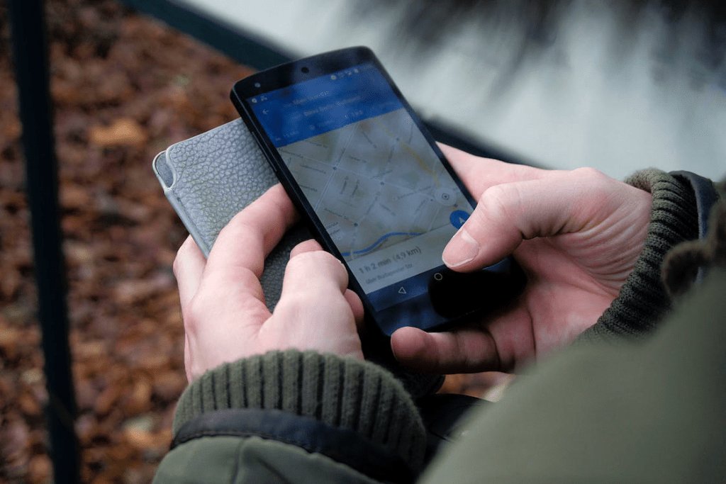 An image of a person using the Google Maps app on a black Android smartphone