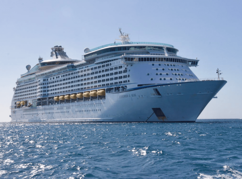 An image of a white cruise ship in the ocean during the day