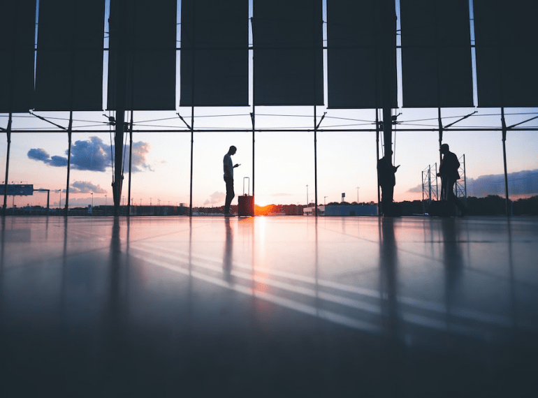 An image of a man in an airport with a suitcase