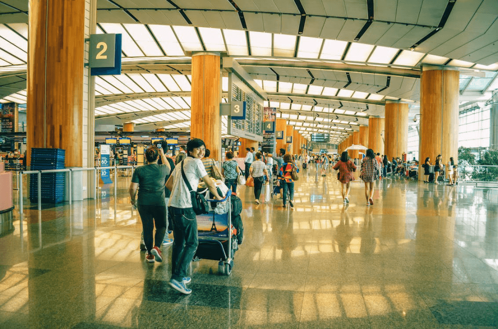 An image of a people standing inside an airport terminal