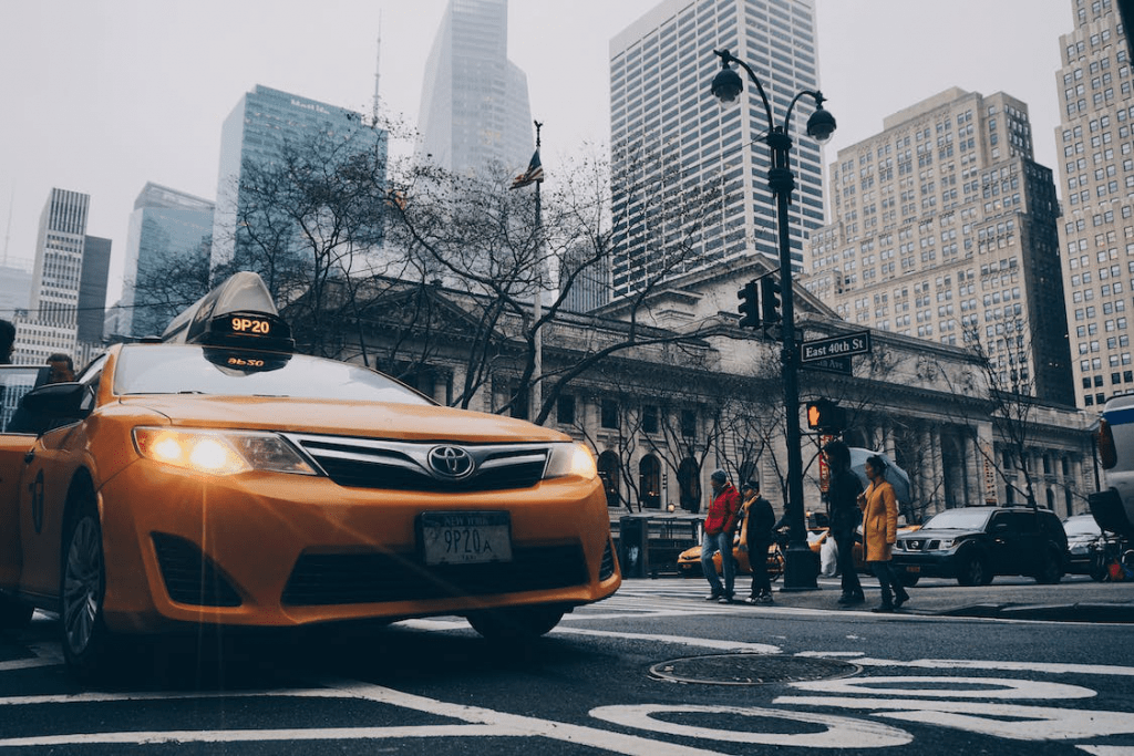 An image of a taxi parked on the side of the street